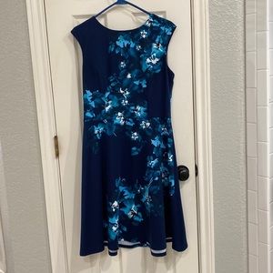 Sleeveless navy dress with floral design.